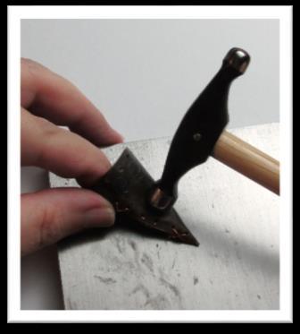 Using the Wubbers Artisan s Mark Round Embossing Hammer and firm strokes, hammer a bend in the cone, while simultaneously attempting to bend the tip of the cone. Try not to hammer the cone flat.