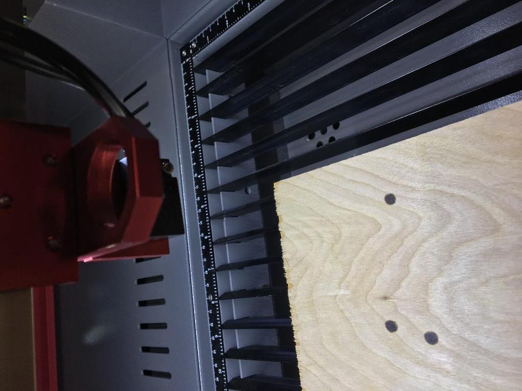 3. With the table and material as close to the laser head assembly as it can get you will pulse into the wood at