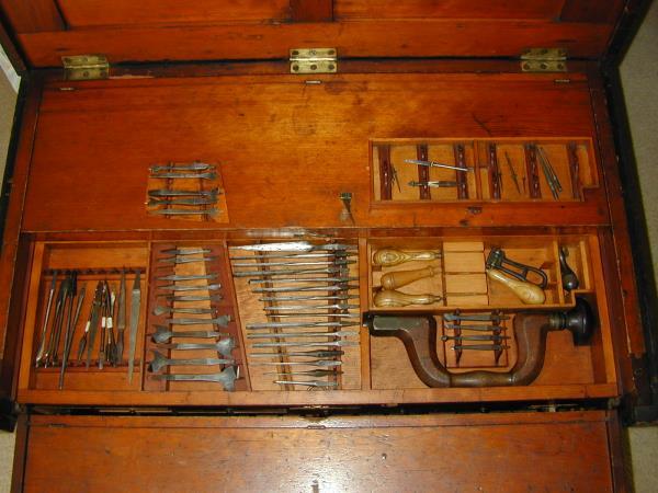 The top section of till #2 contains a wooden brace and all the boring/drilling bits you could imagine. Many are original to the chest in their fitted sections, many are probably not.