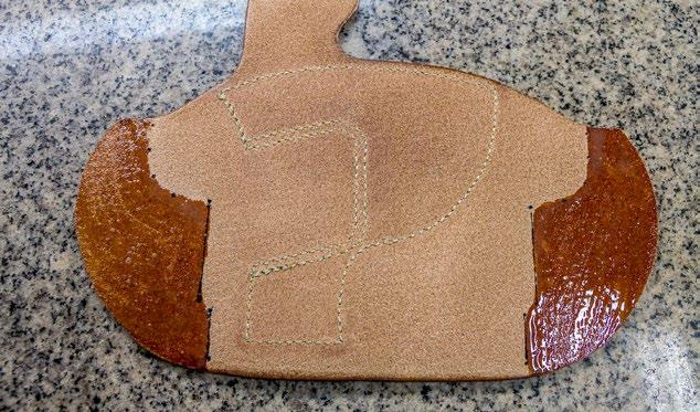 Burnish and dye the perimeter of the holster body just like you did with the reinforcement piece. 23.