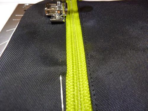 As with most zipper installation, depending on the width of your zipper foot, you may need to stop, with your needle in the down position, lift up