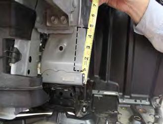 9. On the driver s side of the vehicle, use the utility knife to trim the plastic frame bracket.