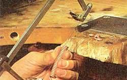 Use a jeweler's saw with 3/0 or finer blades to follow the line, and slit the coil along the tops of thee ovals.