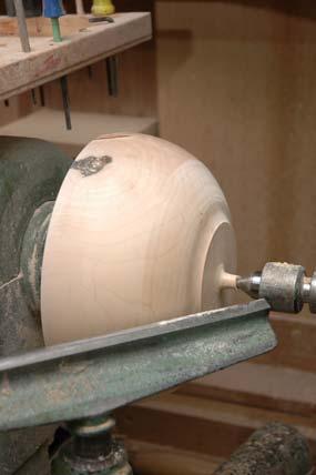 Fig. 13 Fig. 14 The bowl is centered on the chuck aided by the tailstock center mark left from the previous turning processes.