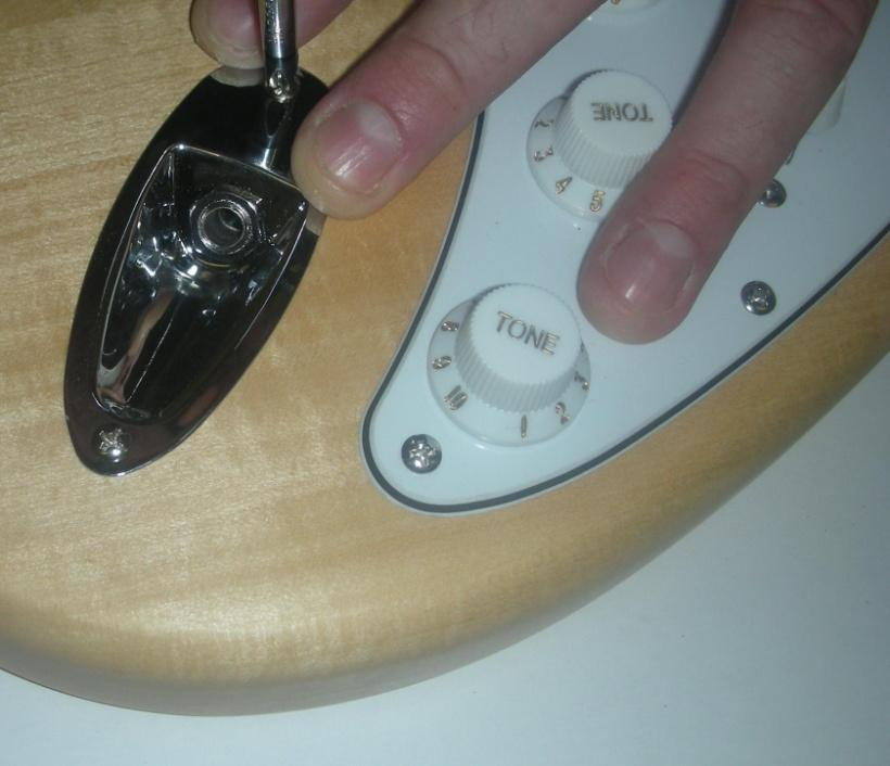 Ensure that the edge of the pick-guard sits snugly to the end of the neck and straight to the