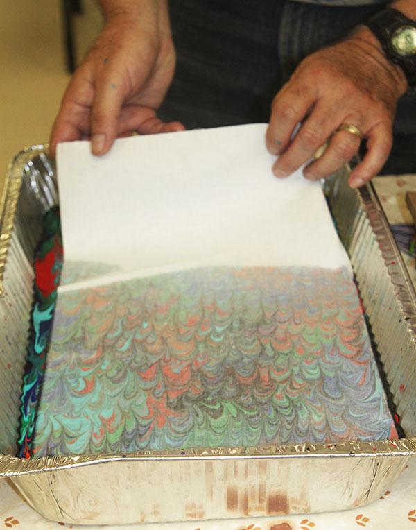 4. Transfer Patterns to Fabric Gently lay the alum treated fabric on top of the floating acrylic paint-pattern.