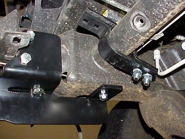 4. Using the holes in the Frame Extensions as guides, drill a 7/16 hole thru the bottom of the frame at the rear end of the brackets.