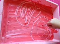 Draw or imprint onto the flat side of the plasticine to create the image, pattern or texture.