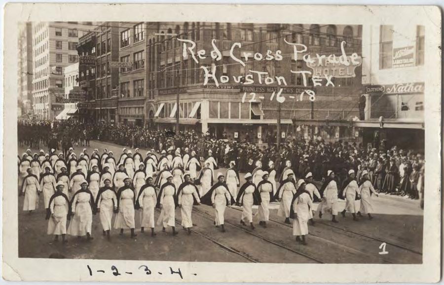 Black and white photograph of a Red Cross parade in Houston, TX.