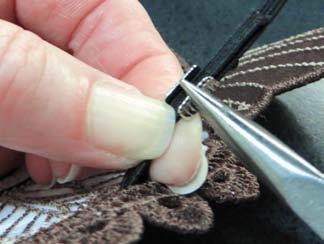 Place a large crimp on the overlapping elastic pieces and squeeze in place.