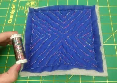 Practice Doodling Blocks The Sulky Sliver Thread has a shimmering, sparkling effect on the royal blue fabric.