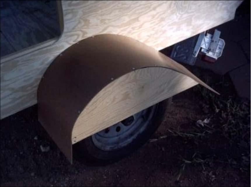 The photo above shows the fender constructed, and the excess waiting to be trimmed. One way to trim the hardboard is the same method for trimming the overhang of the skin material.