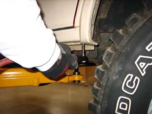 At bottom front of wheel well opening, measure in 2 and make a mark using a grease pencil.