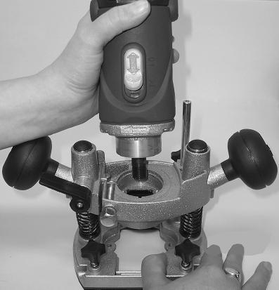 Depress the spindle lock lever (8) and then loosen the collet nut (9) in a clockwise direction with the spanner provided. 2.