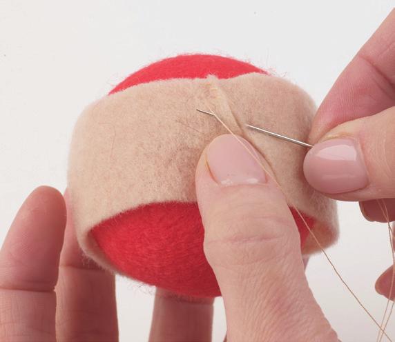 Sandwch the ball wth the two crcles and sew the edges together n one place to secure, takng the needle over and under about 2mm