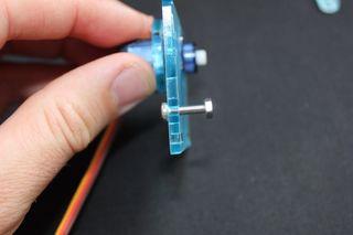 Show All Items Thread the servo through like before and screw onto the side piece using the