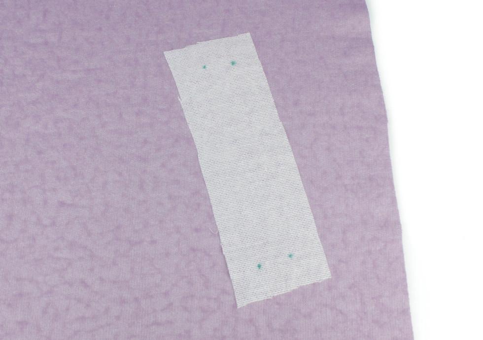 - Attaching the pocket welts - 1. With wrong sides facing up, centre the pocket reinforcement interfacing over the pocket markings and press in place.