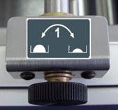 By turning this knob (1) counter-clockwise; Head 1 moves away from the operator side, which will cause