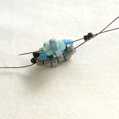 2) Slide all the beads to the end of the thread