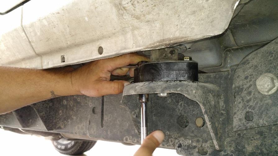 Do not jack the body way up or you risk damaging the mounts on the other side. 11. Use the hammer and the ¾ wrench to hammer the studs out from the sides of each body mount.