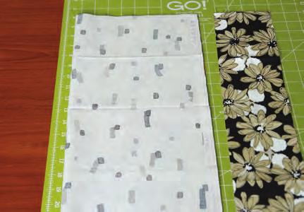 Place light fat quarter right side up on cutting mat with selvage on left.