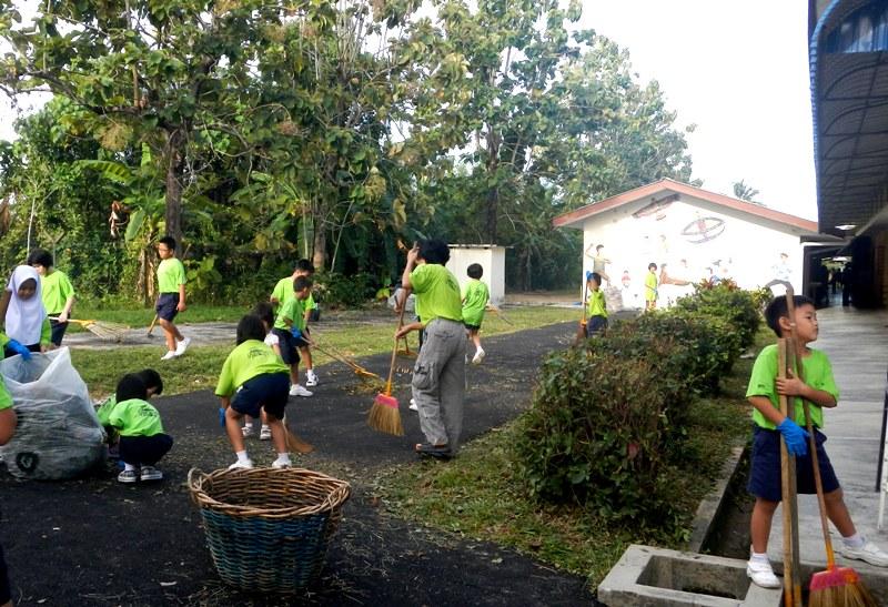 Teachers, school kids and their parents worked together to clean up the school area.
