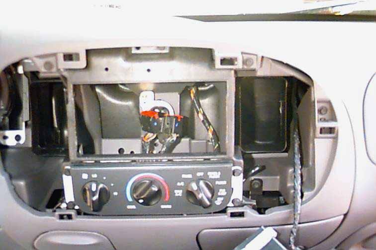 STEP 2: Once the radio installation kit is securely mounted to the opening in the dash, mount and secure the radio to the installation kit. Plug in the antenna cable into the rear of the new radio.