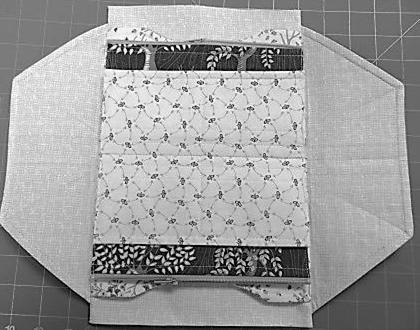 Sew both long seams twice and trim to reduce the bulk before turning. Turn right sides out and press. Step 16 Closing the Card Pockets In step 11 you added the card pockets.