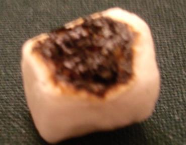 The radiation heating from the flame could also cause the marshmallow to have a high temperature than the measured temperature. At short distance, less than 0.