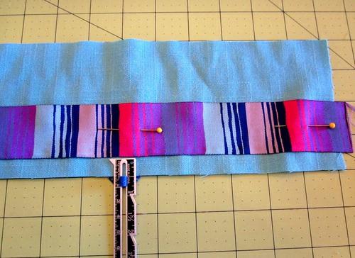 Place the ribbon horizontally across the fabric strip with the top edge of the ribbon ½" (and just a bit extra) from the top raw edge of the fabric.