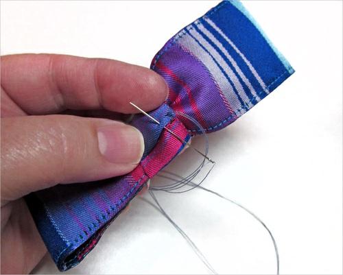 11. With the hand needle and thread, whip stitch the ends to secure. 12. The bow can be stitched in place right on the waistband (positioning as shown in our photos above) or pinned in place.