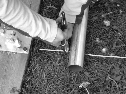 Insert the remaining end of the cable through the other rafter bolt holes, measure the 28' on-center width dimension, and clamp the legs in place to prevent the rafter from spreading as