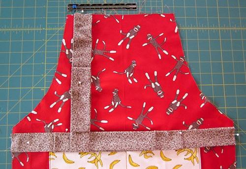 Pin the tails of the ties to the middle of the apron to keep them out of the way of the final seam. 8.