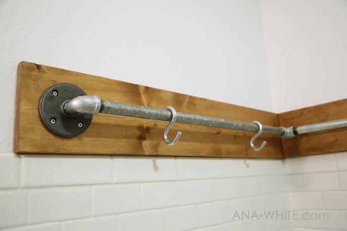 And mounted 3/4" iron pipes to the wall using floor flanges and street elbows (I also backed mine in a 1x6 board with 1 coat of Rustoleum Early American).