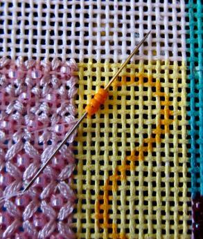 Anchor it on the back of the canvas by piercing a canvas thread. STEP 2: Start by stringing 3-4 beads on the thread.