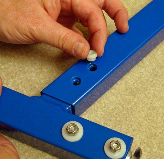 Remove screws and nylon washers from vertical sling supports and slide each vertical support