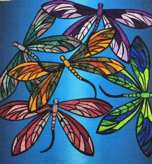 Dance of the Dragonflies By Joann Hoffman This wall hanging is stunning in beautiful colourful batiks. Using the appliqué formula you too can create your own piece of art.