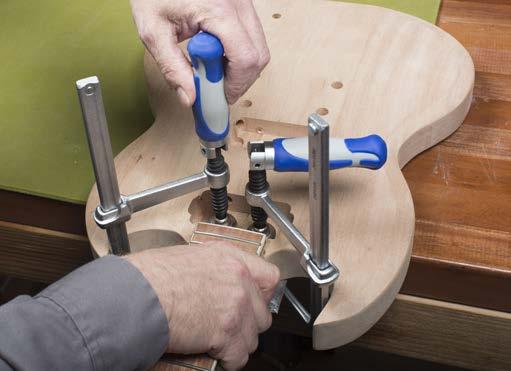 Using two clamps and a caul on the back of the body to prevent denting the wood lightly clamp the neck into place.
