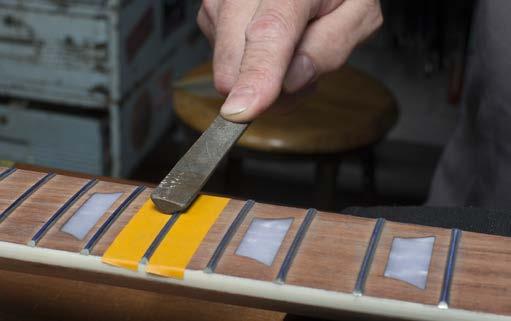 Fretwork Color the fret tops with a blue permanent marker to prepare them for leveling.