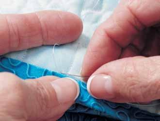 Take a stitch outside of the seamline as shown in Photo. The length of your stitch should be about ¼". 4.