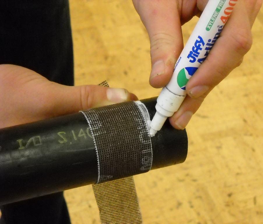 Students align the wrap and mark the pipe with pencil, permanent marker, or paint marker.
