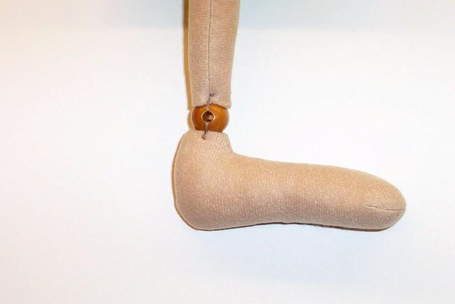 Next, sew a bead to the top of lower leg for the knee joint.