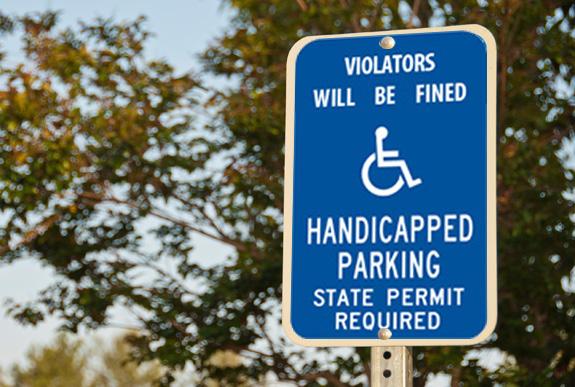 TRAFFIC AND PARKING SIGNS Handicapped Parking Size: 12 inches wide x 18 inches high Color: White copy on field Corners: 1 1/2 inch radius Reflectivity: Reflective Holes: Two 3/8 inch
