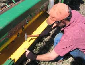 9 Remove the header from the combine. Using the pre-drilled holes as a guide, drill thru with the 9/32 drill bit supplied.