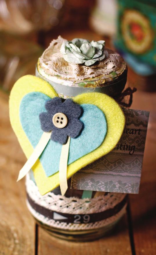 Gather a length of wide lace to create a rosette and stick it to the lid, along with a paper bloom, using a glue gun.