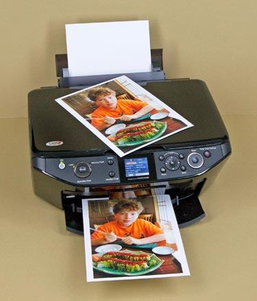 ) prints photographs from 4x6-inch to 8.5x11 and A4 sizes, both with and without borders. The all-in-one unit prints, copies, and scans with or without a PC.