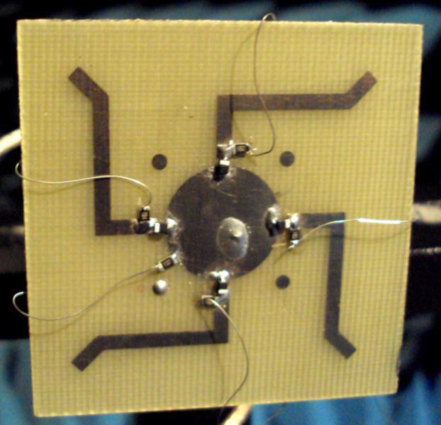 Fig. 5.25 Photograph of fabricated antenna with PIN diode BAR63. The top side is showing patch, four diodes and bias circuit Fig. 5.26 A simple biasing arrangement for BAR63 PIN diodes on the patch.