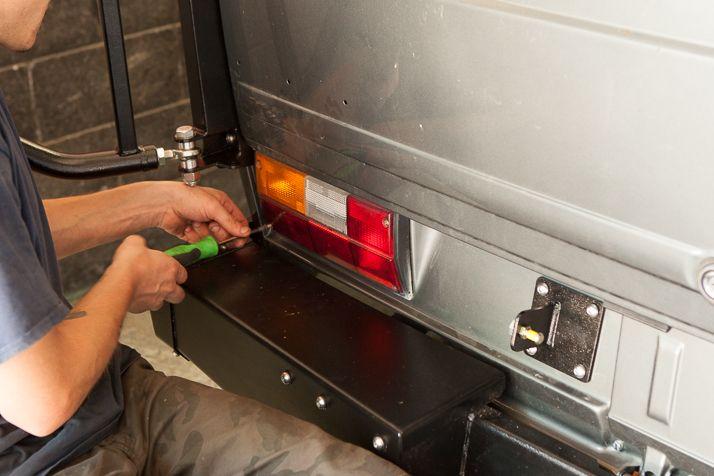 Plug the tail light back up and use a Phillips Head Screwdriver in order to