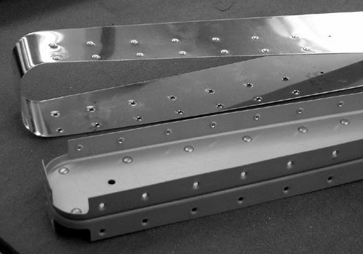 pattern and spacing. Be sure the leading edge of the skin is tight to the nose of the ribs before drilling. Deburr and dimple these attach holes, but do not rivet at this time.