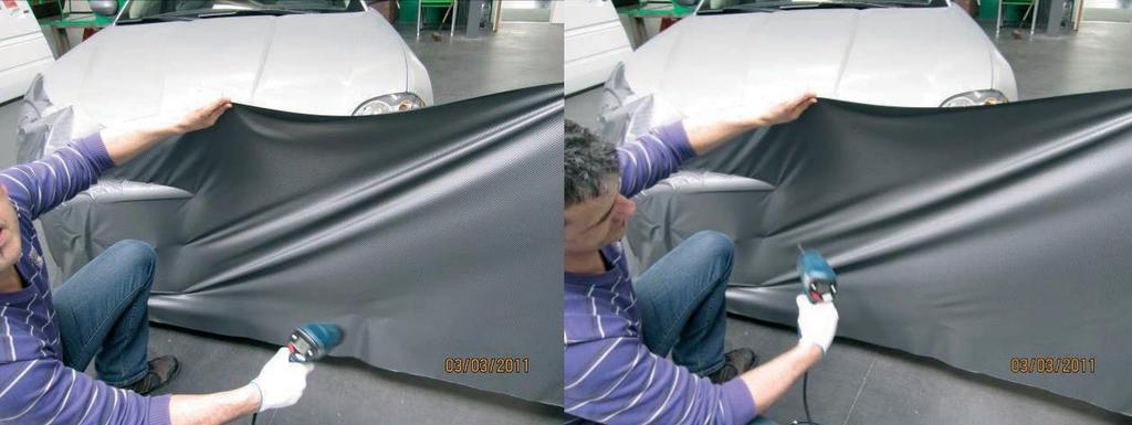 7 Pull the vinyl off the car again at one side of the fixated part, and heat the vinyl by means of a heat gun. For large surfaces, we recommend that you set the temperature of the heat gun to 600 C.